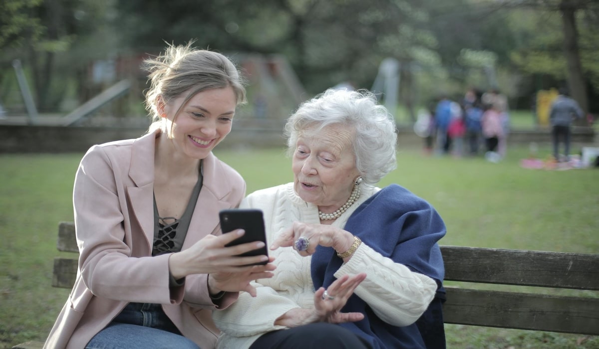 A woman shows her mother how to find out if their phone is traced.