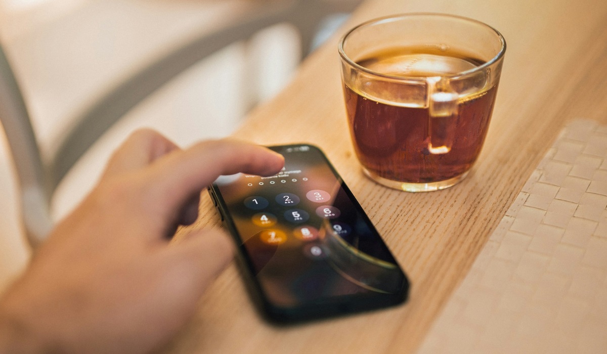 A man holds his iPhone in an anti-theft case to protect it from pickpockets.	