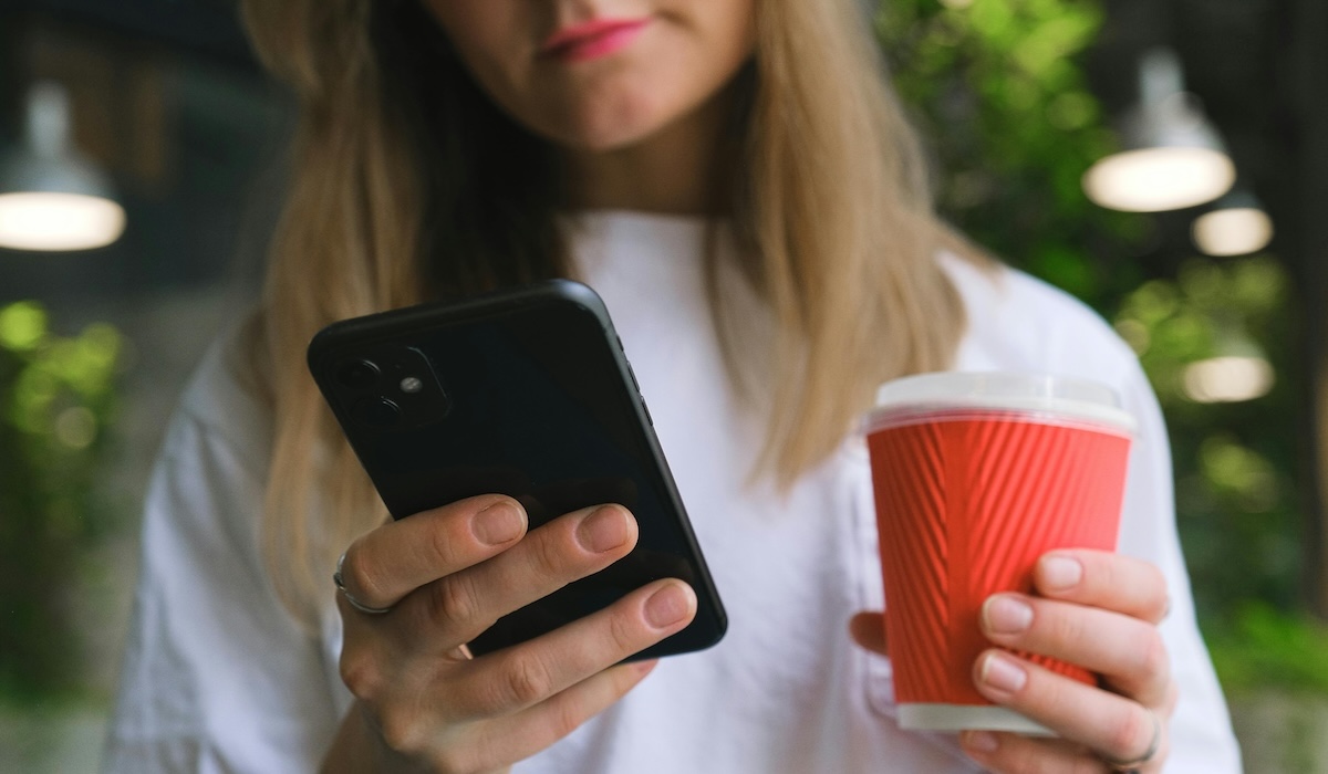 A woman uses an application to change her iPhone location.