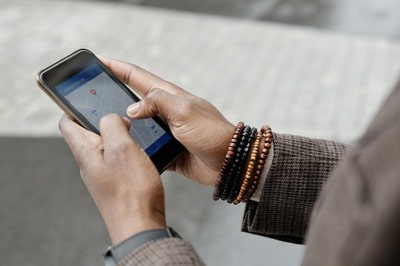 A man uses an online map to find a person's address and phone number.