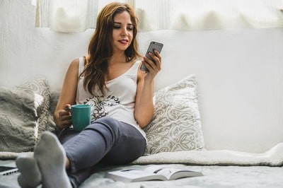A woman uses an application to locate an incoming call with her cell phone.