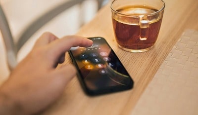A man types his code into his phone to see how to find a lost mobile with the IMEI.	